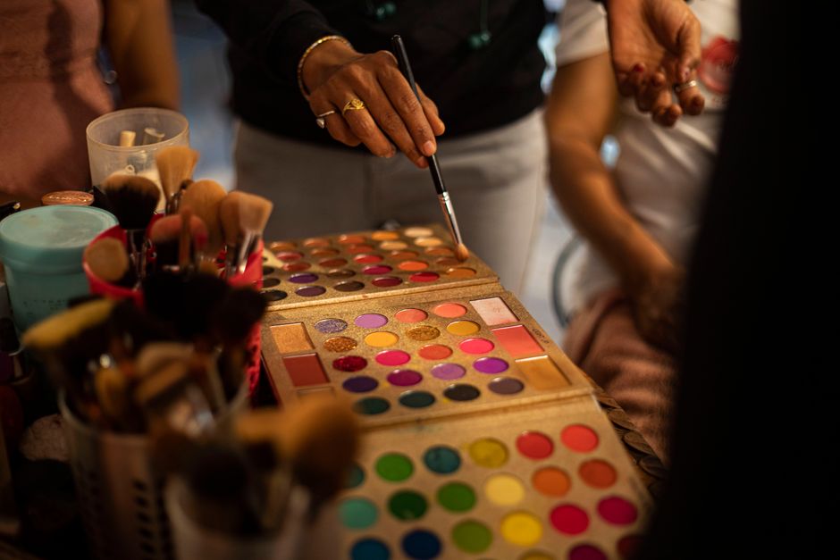 Colorful eyeshadow palette and brushes in a lively beauty setting.