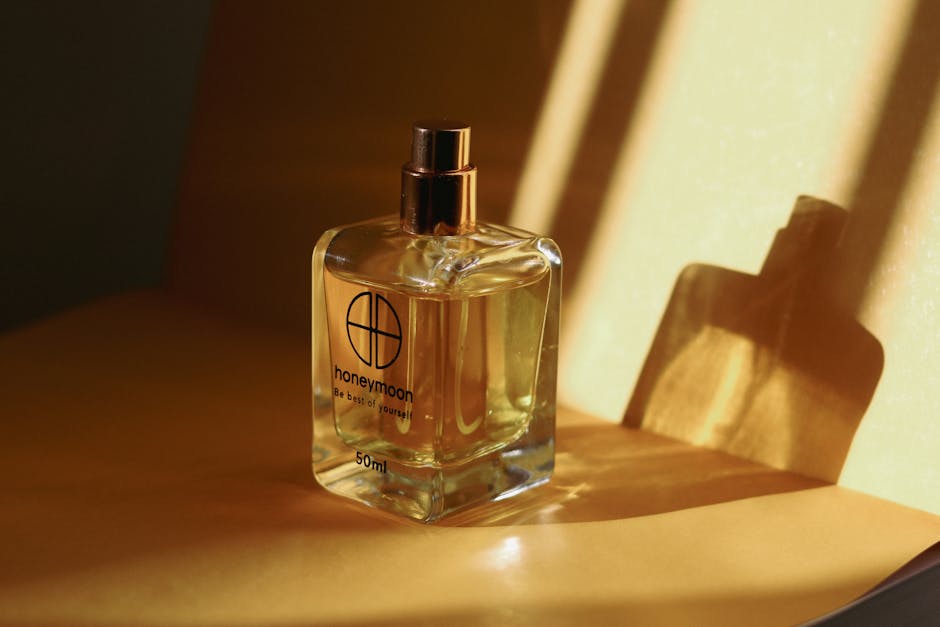 Close-up of a perfume bottle with warm shadows and reflections, perfect for aromatics.